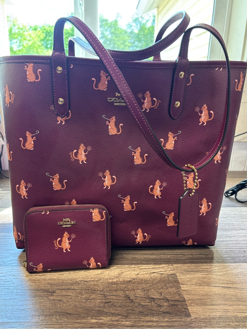 LIKE NEW Coach Reversible City Tote in a burgundy "Party Cat" print w/ Wallet